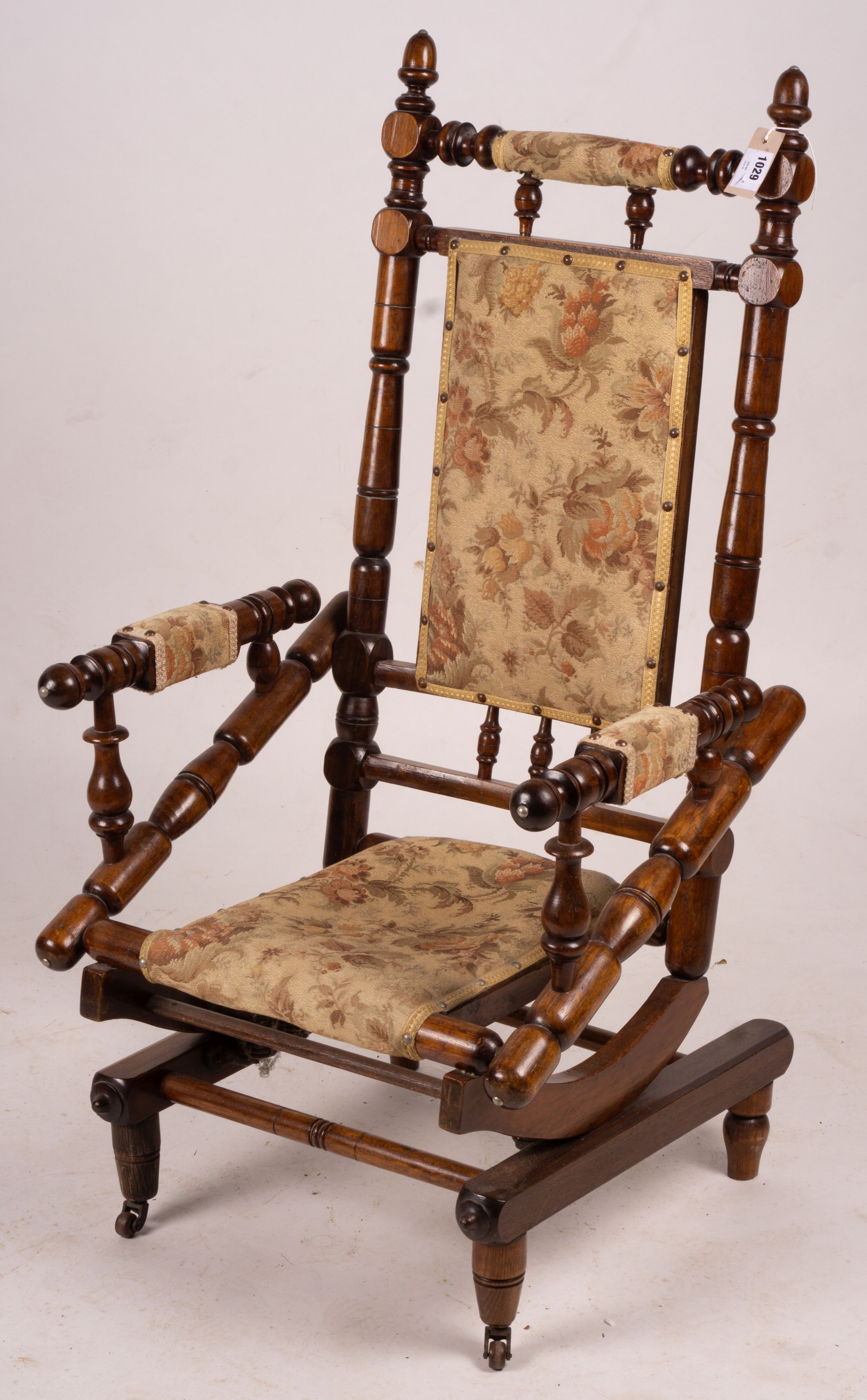 An early 20th century American turned mahogany rocking chair